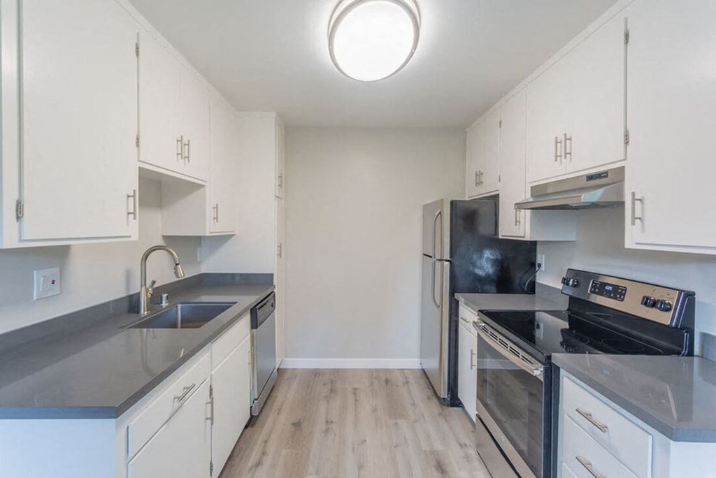 an empty kitchen with stainless steel appliances and white cabinets at Element LLC, Sunnyvale, CA, 94086