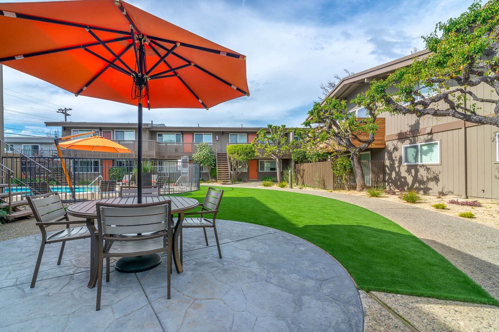 a patio with a table and chairs and an umbrella at Element LLC, Sunnyvale
