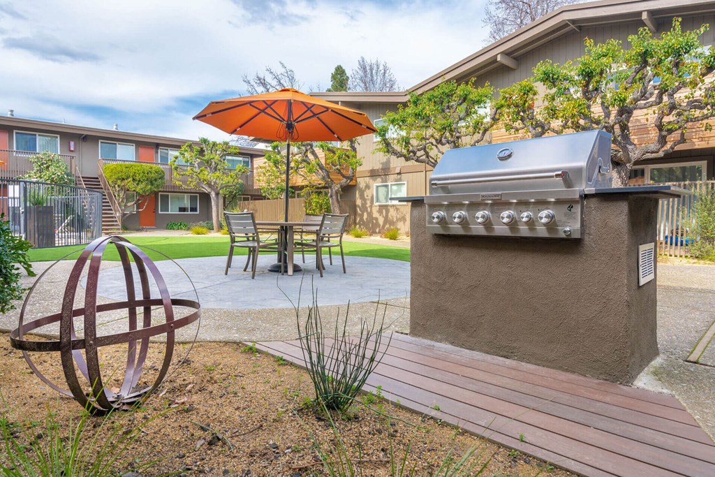 a patio with a grill and a table with an umbrella at Element LLC, Sunnyvale, CA