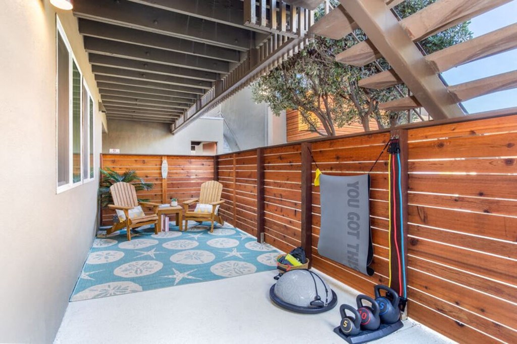 a patio with a wooden fence and a pair of shoes on the floor at Element LLC, Sunnyvale, CA