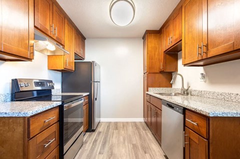 a kitchen with wooden cabinets and stainless steel appliances