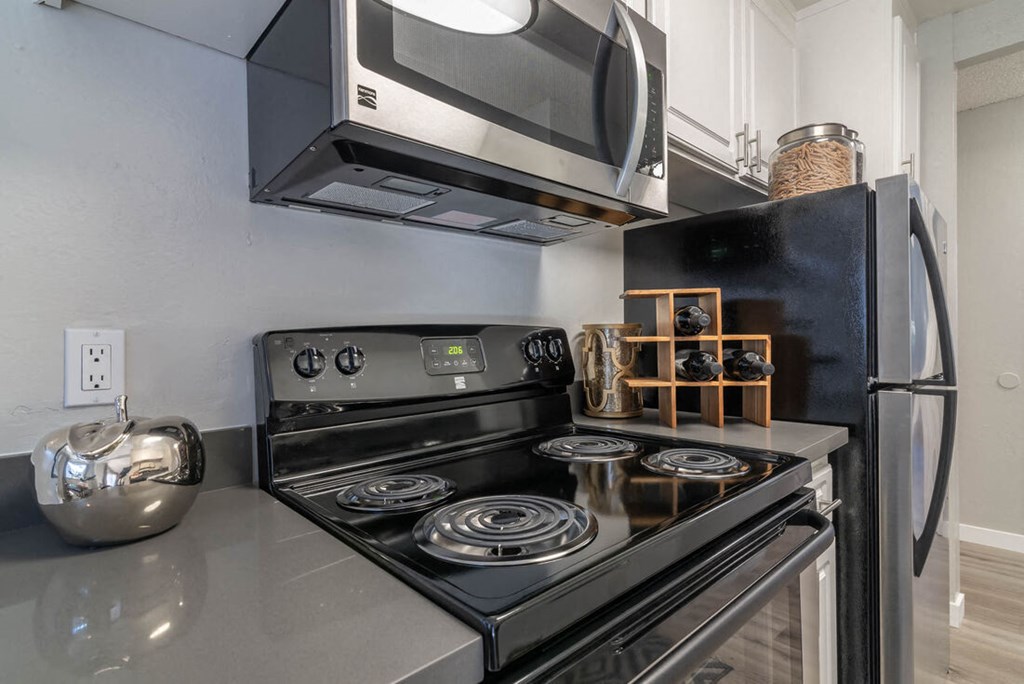 Kitchen with a stove and a microwave at Sunnyvale Crossings Apartments, Sunnyvale, CA, 94087