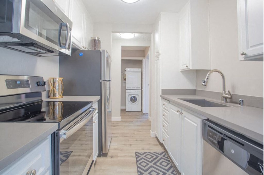 Kitchen with white cabinets and stainless steel appliances at Sunnyvale Crossings Apartments, Sunnyvale, CA, 94087