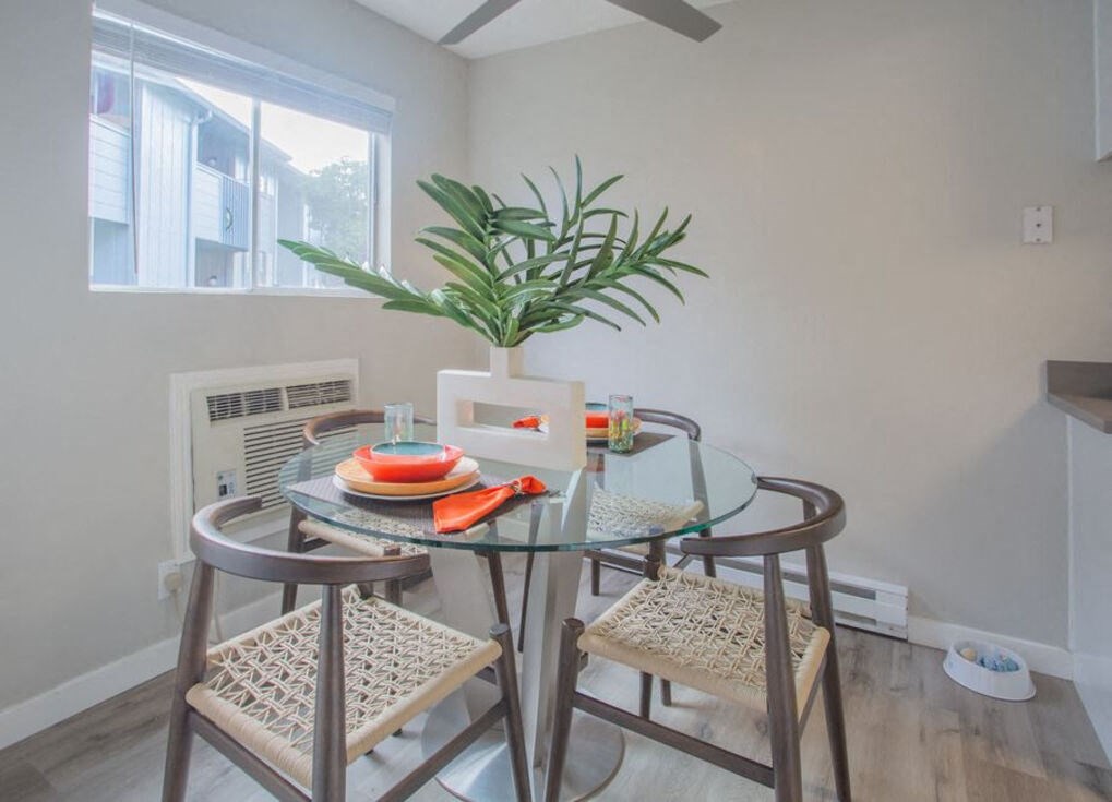 a dining room with a glass table and chairs a dining room with a glass table and chairs at Sunnyvale Crossings Apartments, LLC, California, 94087