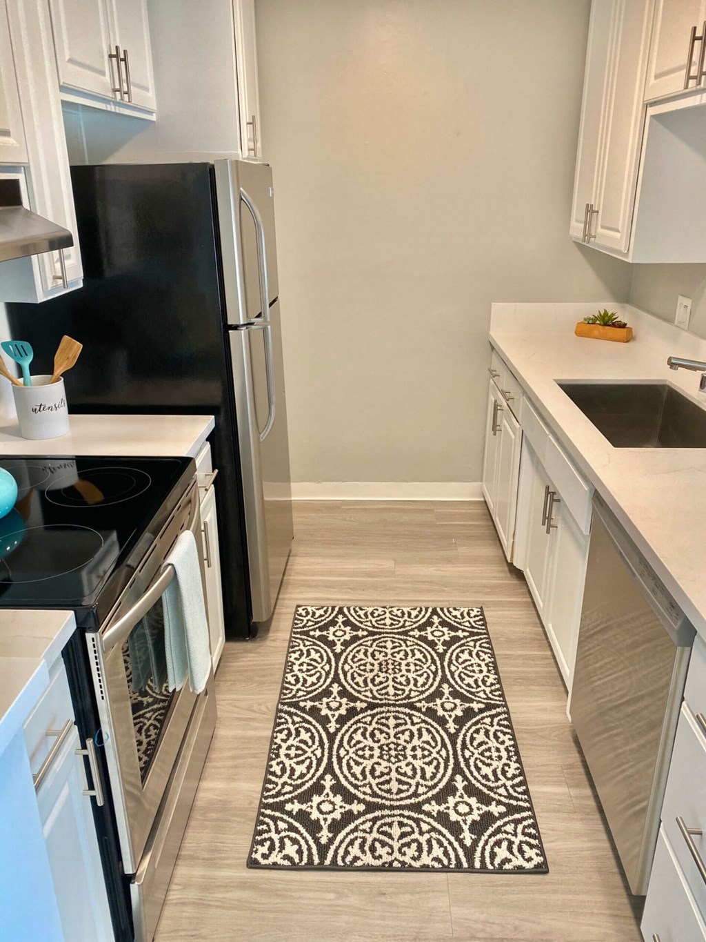 a kitchen with a rug in the middle of the floor at The Flats on Addison, Sherman Oaks California