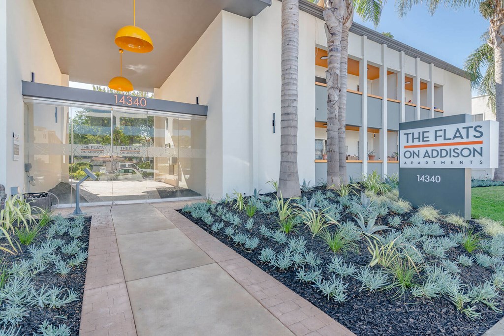 the flats on adelaide building entrance with palm trees at The Flats on Addison, Sherman Oaks, 91423