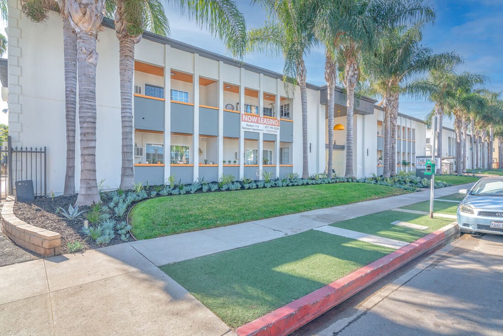 the front of a building with palm trees in front of it at The Flats on Addison, California