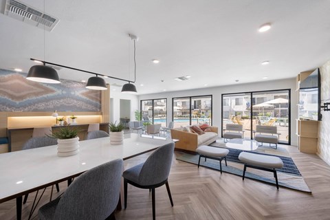 A modern dining area with a long table and chairs at Latitude Apartments at Mission Valley Apartments, San Diego
