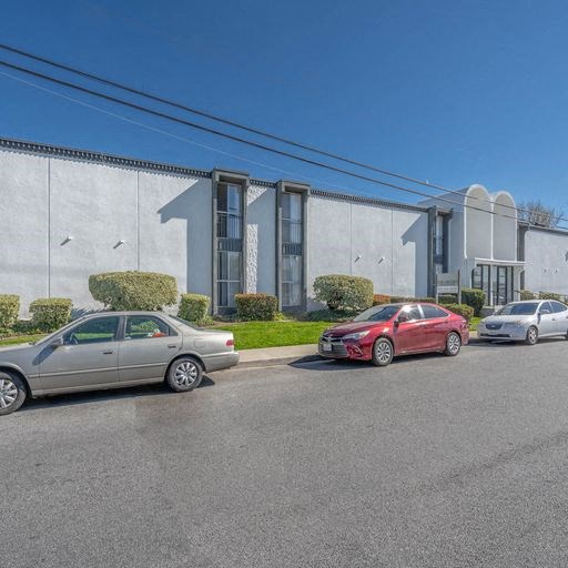 a building with cars parked in front of it at The Arches Apartments, California