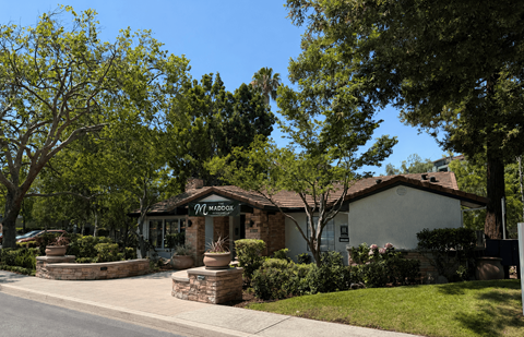 A house with a sign that says "Maddox" in front of it.