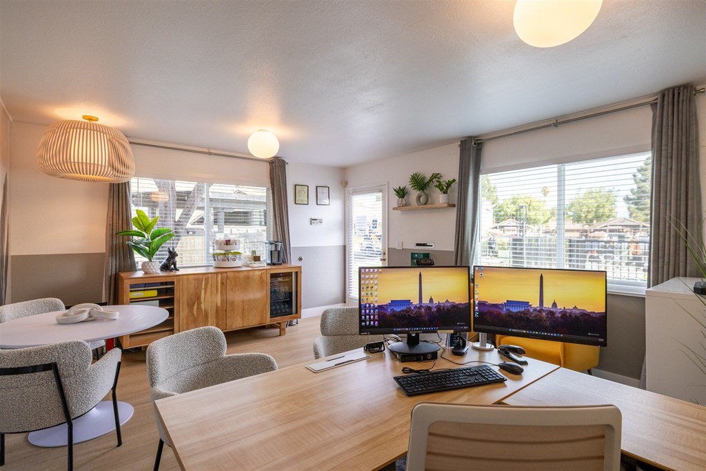 A modern home office with a large desk, dual monitors, and comfortable seating.at Summerhill Place Apartments, Union City 