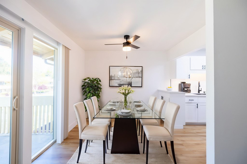 A dining room with a table set for six at Summerwood Apartment , California, 95050