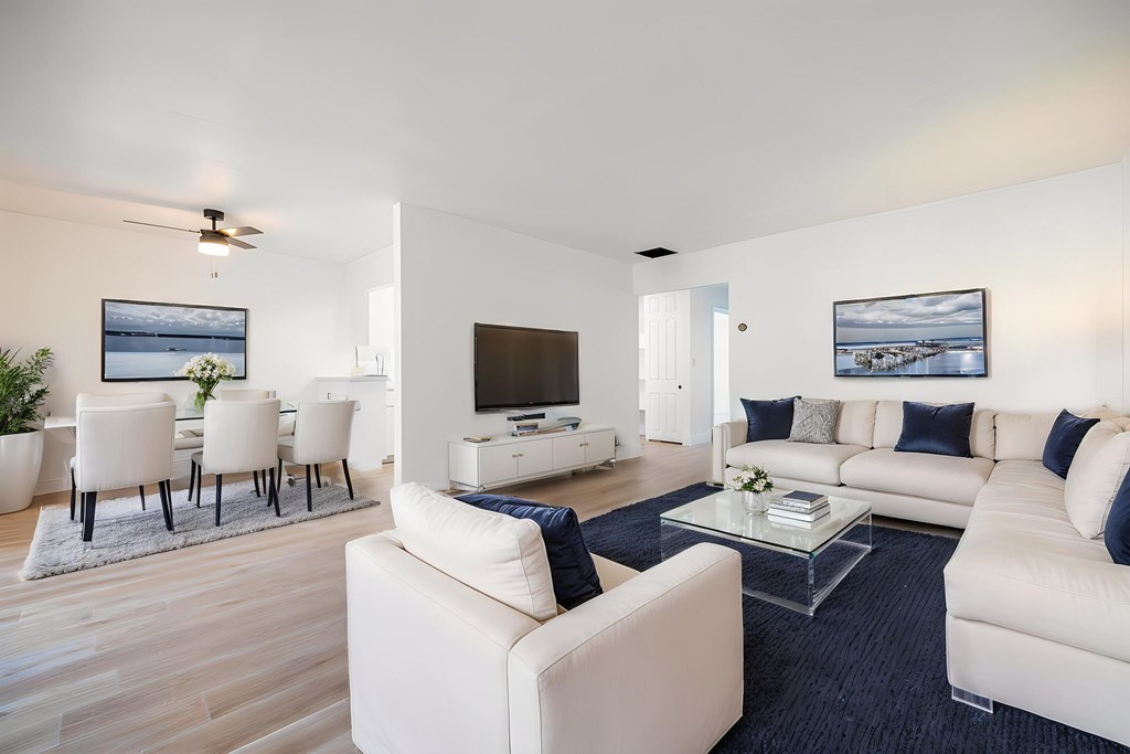 A modern living room with white furniture and a flat screen TV at Summerwood Apartment , Santa Clara