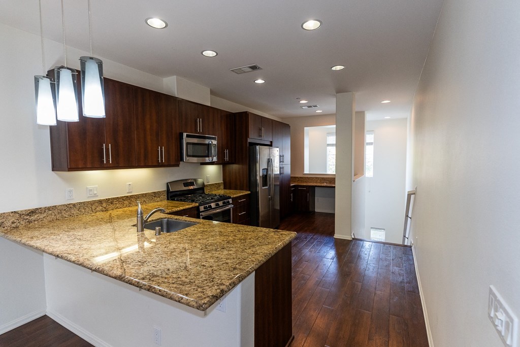 a kitchen with a granite counter top and a at The Vines at Riverpark, LLC, California, 93036