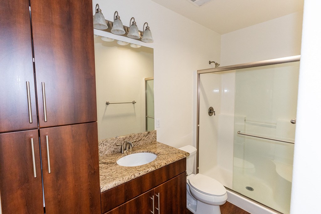 a bathroom with a sink and a shower and a toilet at The Vines at Riverpark, LLC, California, 93036