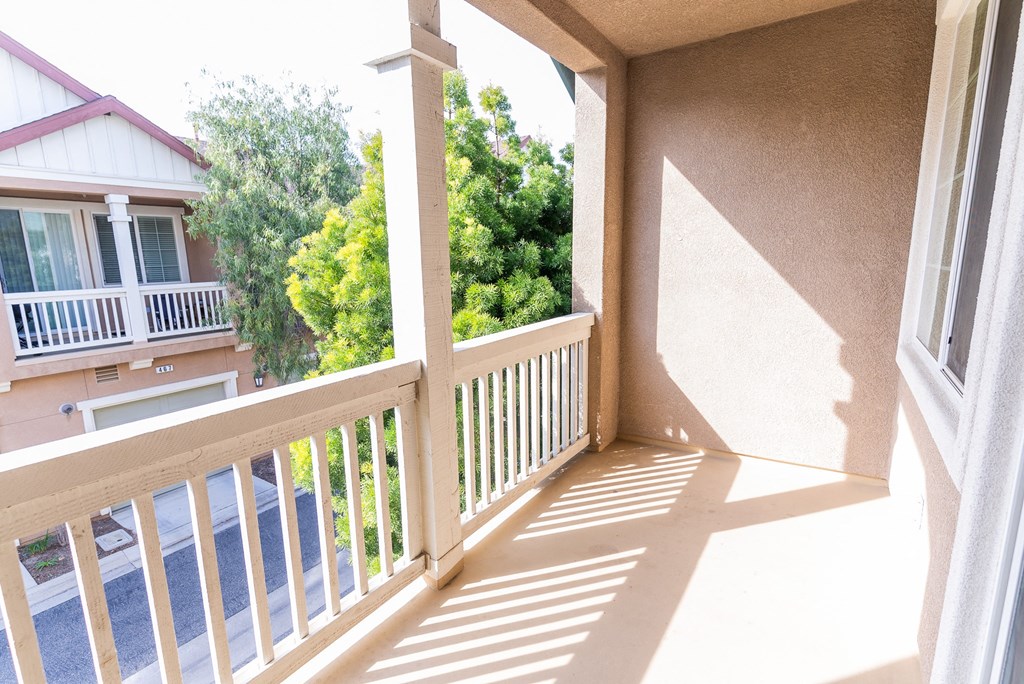 a balcony with a view of trees and a house at The Vines at Riverpark, LLC, California, 93036