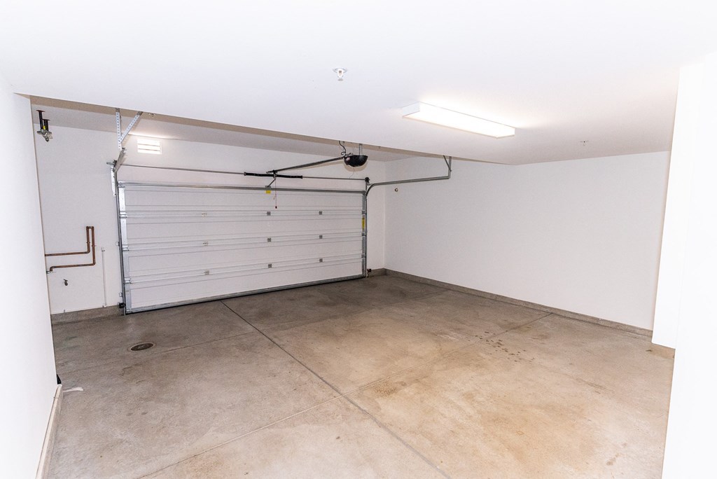 the inside of a garage with a white door at The Vines at Riverpark, LLC, California, 93036