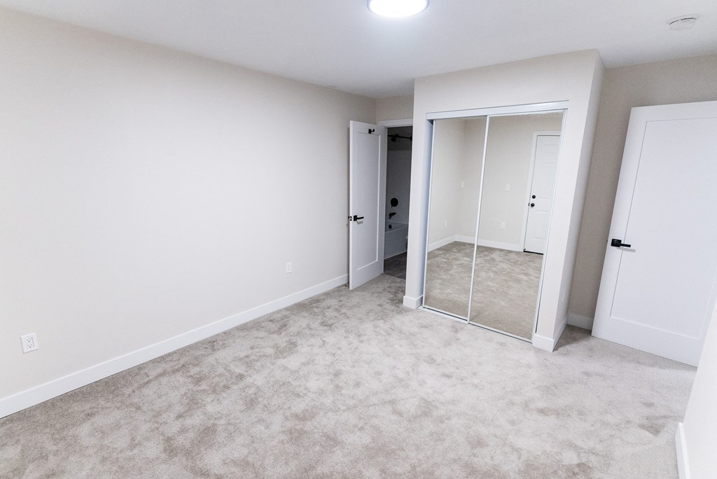 empty bedroom with a mirrored closet  at The Flats on Addison, Sherman Oaks