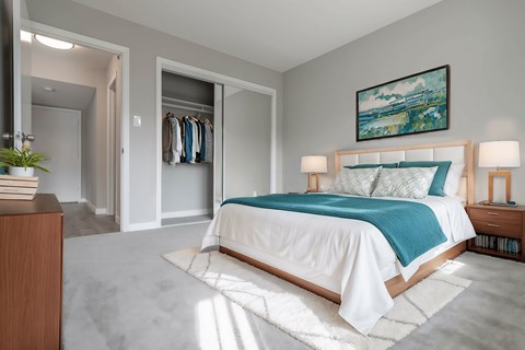 A bedroom with a bed, a dresser, and a painting on the wall at The Pier at Sausalito, Sausalito