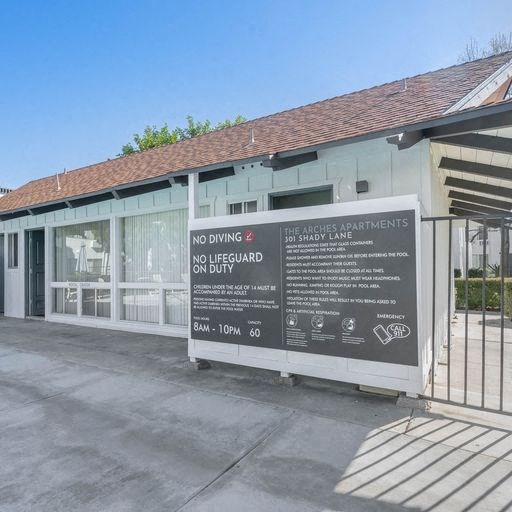 a large sign in front of a building at The Arches Apartments, El Cajon, 92021