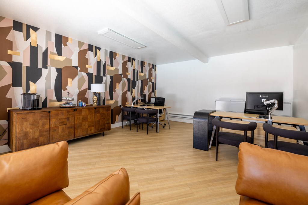 a living room with couches and chairs and a desk with a computer at Campbell West Apartments, Campbell, CA 95008