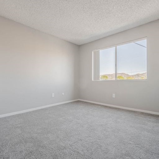 an empty room with a large window in it at The Arches Apartments, El Cajon, CA 92021