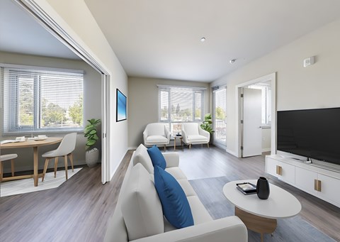 A modern living room with a grey sofa and a television.