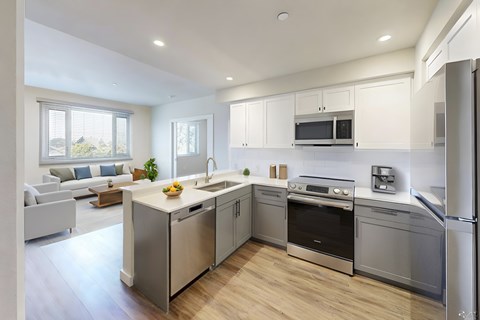 A modern kitchen with stainless steel appliances and a wooden floor.at 888 Fourth Street Apartments, LLC, Santa Rosa, CA