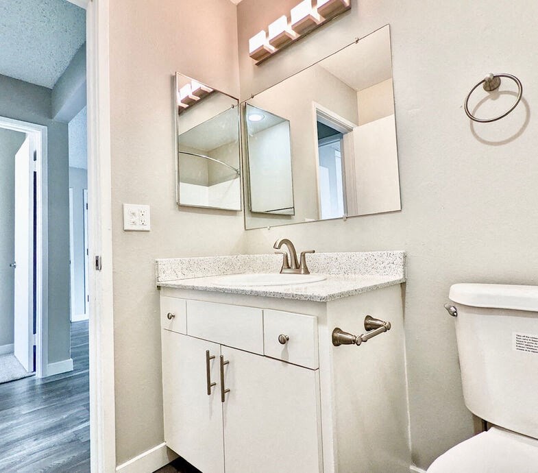 a bathroom with a sink and a mirrorat The Arches Apartments, LLC, California