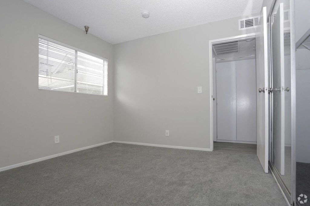 an empty bedroom with a closet and a window an empty bedroom with a closet and a window at The Marq Apartments LLC, California