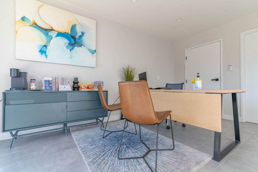 a desk and chair in a room with a door at BLVD Apartments LLC, Tarzana, 91356