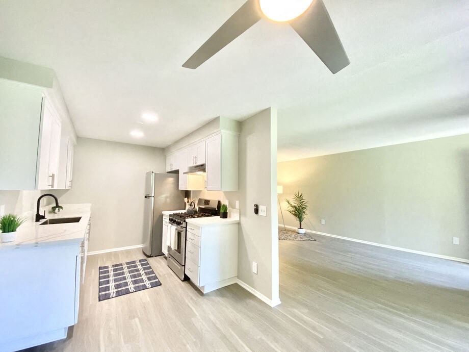 an open kitchen and living room with a ceiling fan at BLVD Apartments LLC, Tarzana California