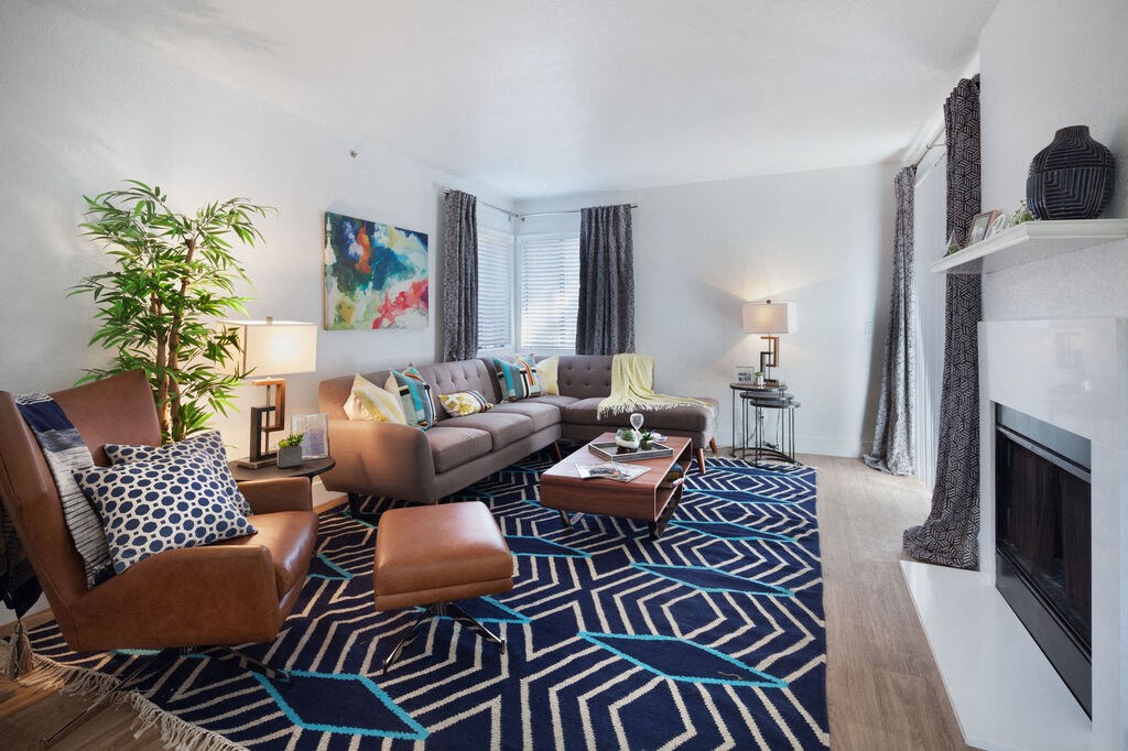 a living room with a couch and a fireplace at The Bryant, Yorba Linda California