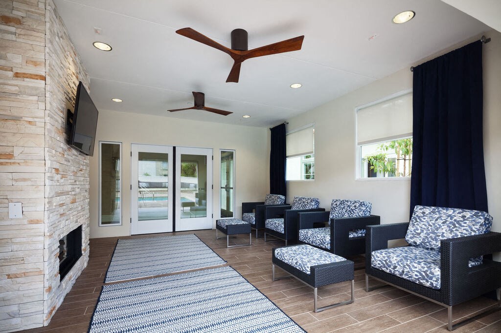 a living room with a couch and chairs and a fireplaceat The Bryant, Yorba Linda California
