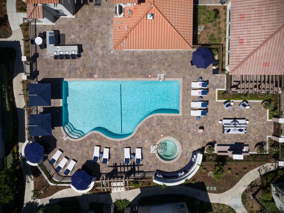 an aerial view of a swimming pool at a resort with umbrellas and chairs at The Bryant, California