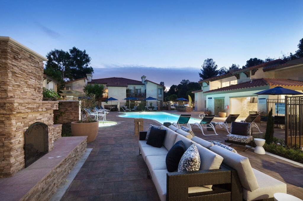 a backyard with a pool and patio furniture at The Bryant, California