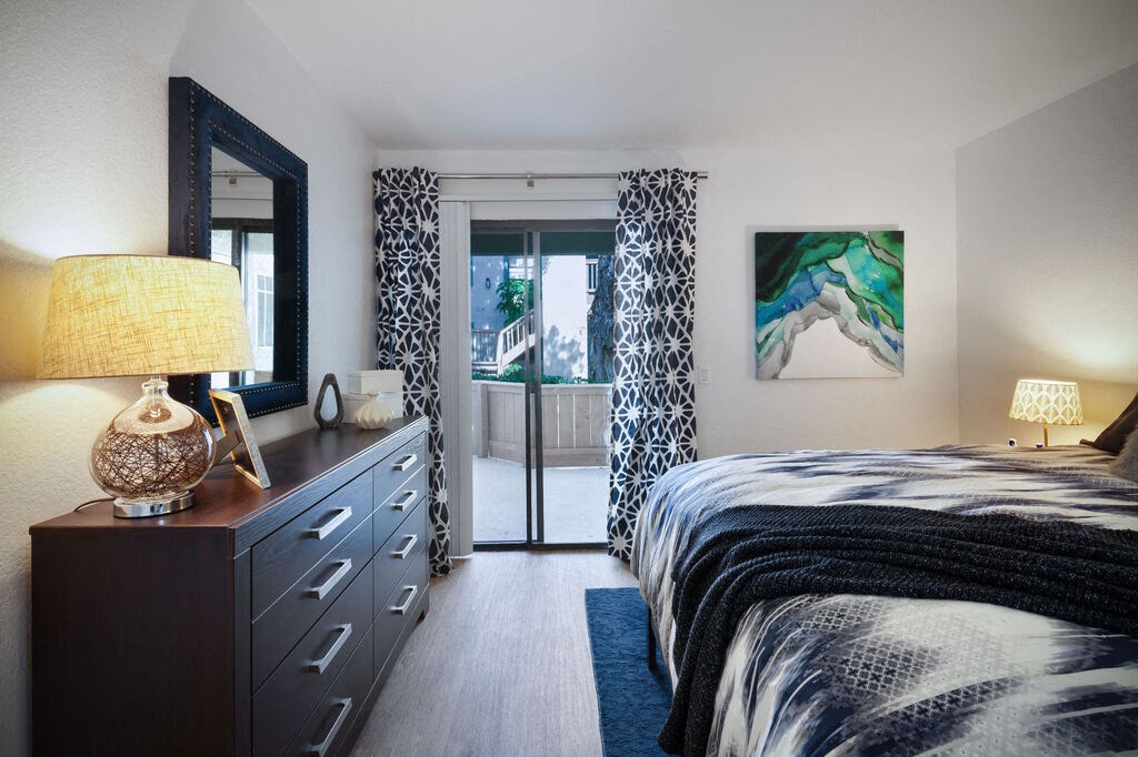 a bedroom with a bed and a door to a balcony at The Bryant, Yorba Linda California