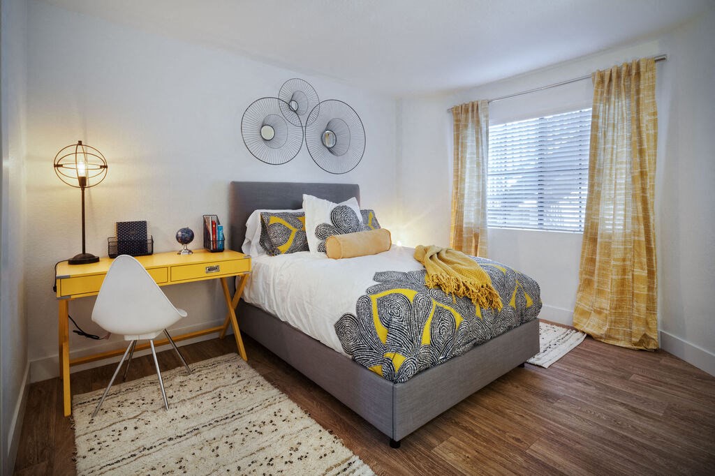 a bedroom with a bed and a desk at The Bryant, Yorba Linda