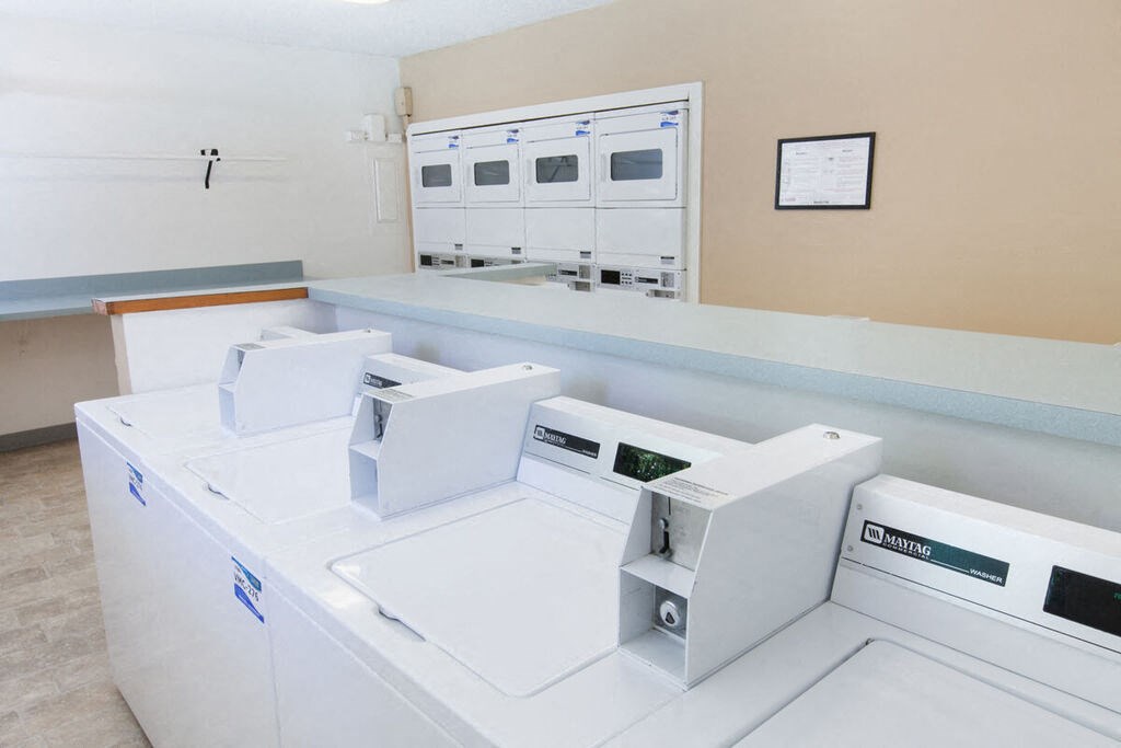 four washing machines in an empty laundry room with a counter at Campbell West, Campbell, CA 95008