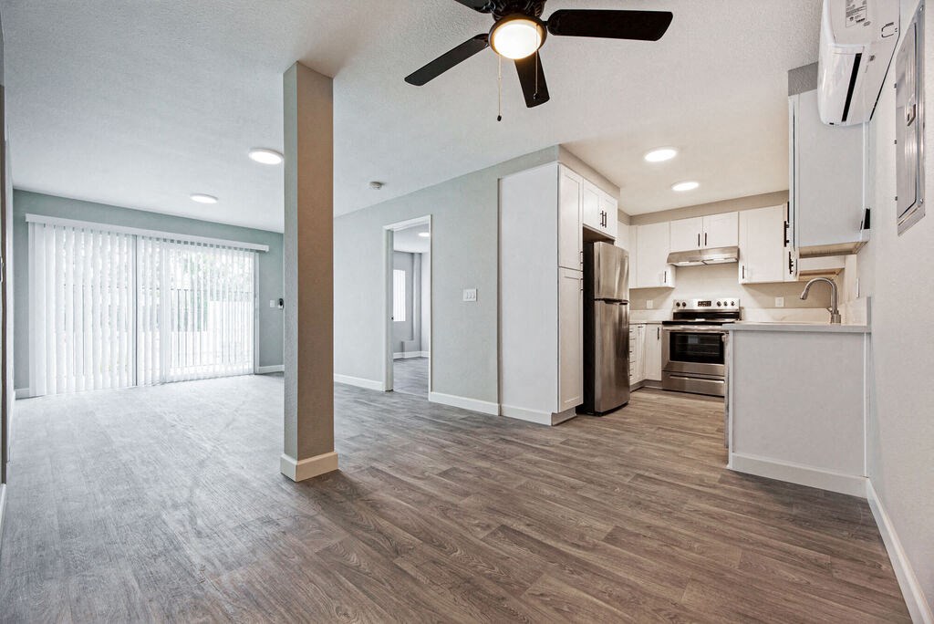 an open kitchen and living room with a ceiling fan at Citra Apartments LLC, San Diego, California