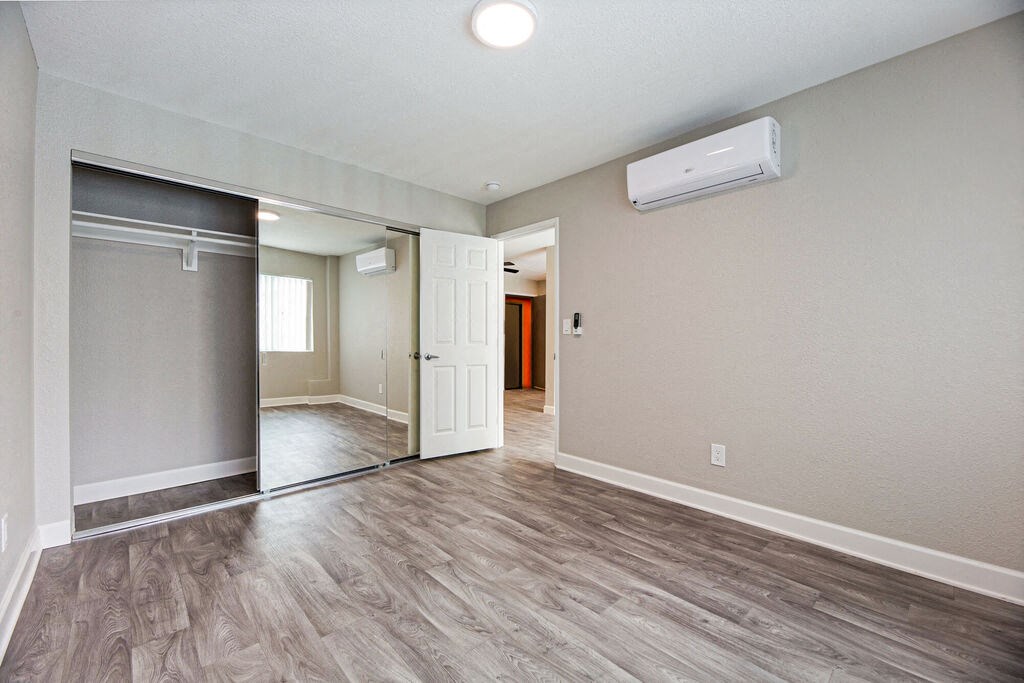 an empty living room and hallway with a door to a closet at Citra Apartments LLC, San Diego