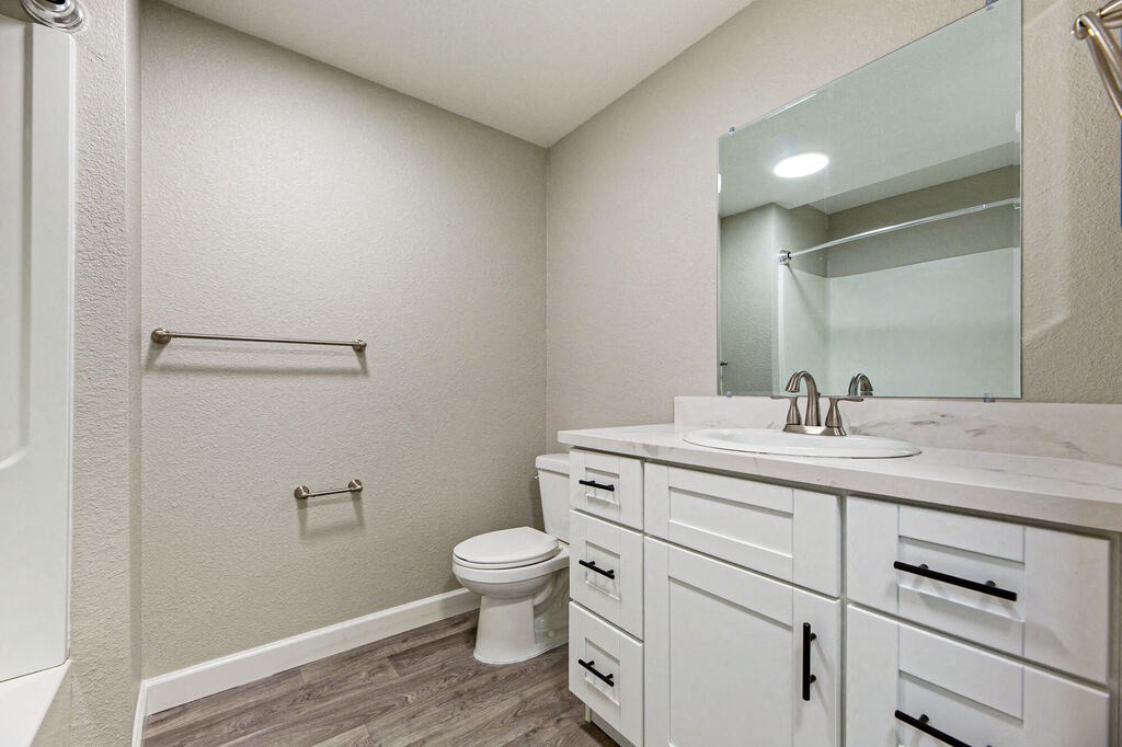 a bathroom with a sink toilet and a mirror  at Citra Apartments LLC, California, 92107
