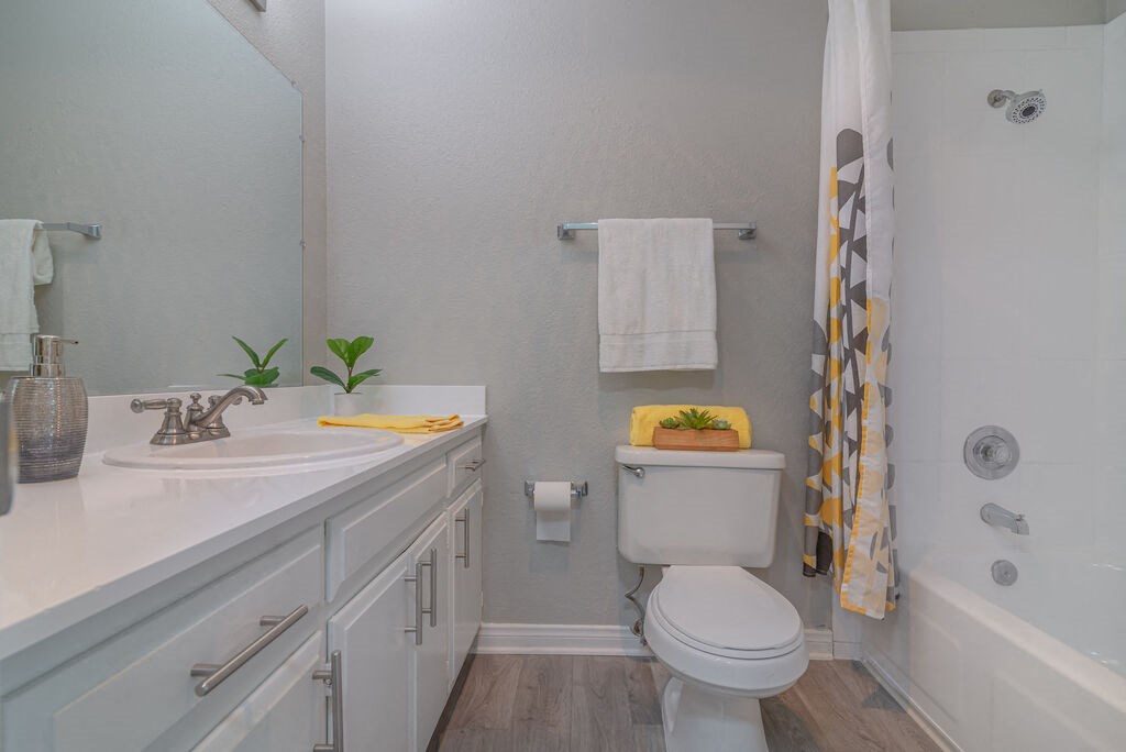 a white bathroom with a toilet and a sink at Citra Apartments LLC, California, 92107