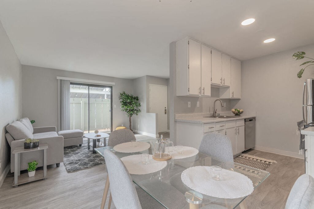 a living room and kitchen with a table and chairs at The Gates at The Marina Apartments, Marina