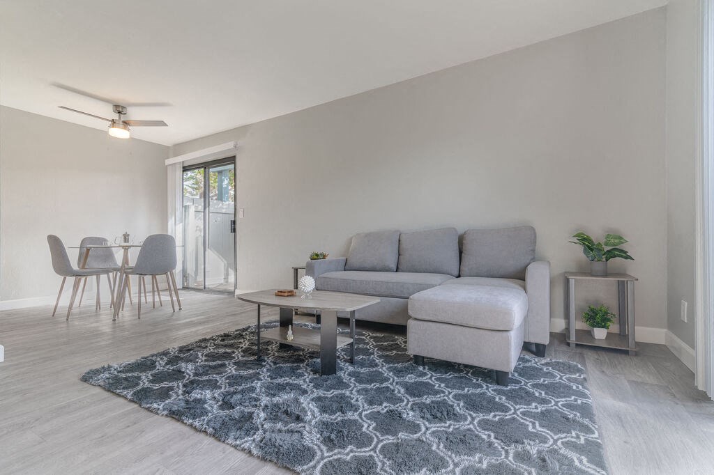 a living room with a couch and a coffee table at The Gates at The Marina Apartments, Marina, CA