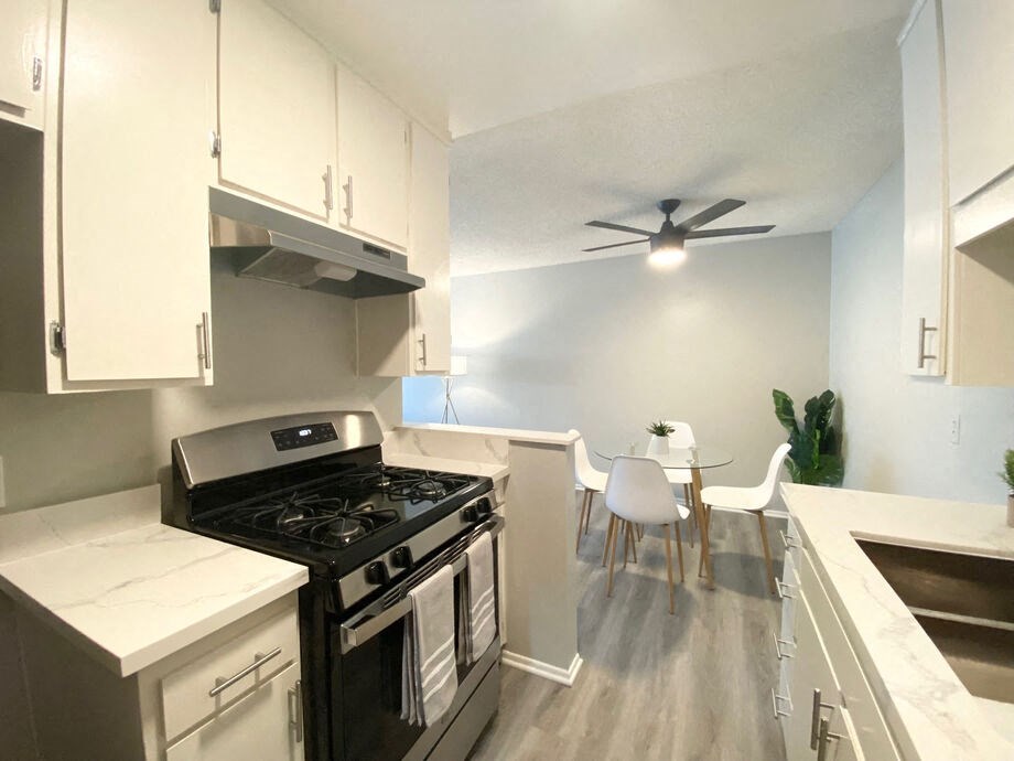 a kitchen with a stove and a ceiling fan at The Hills Apartments at Thousand Oaks, Thousand Oaks, CA 91360