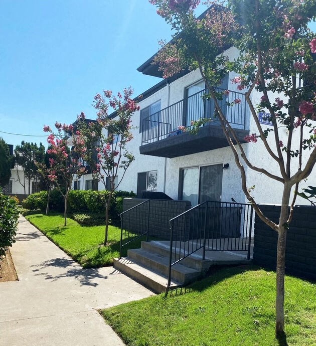a white house with a sidewalk in front of it at Latitude Apartments at Mission Valley, San Diego, CA 92120