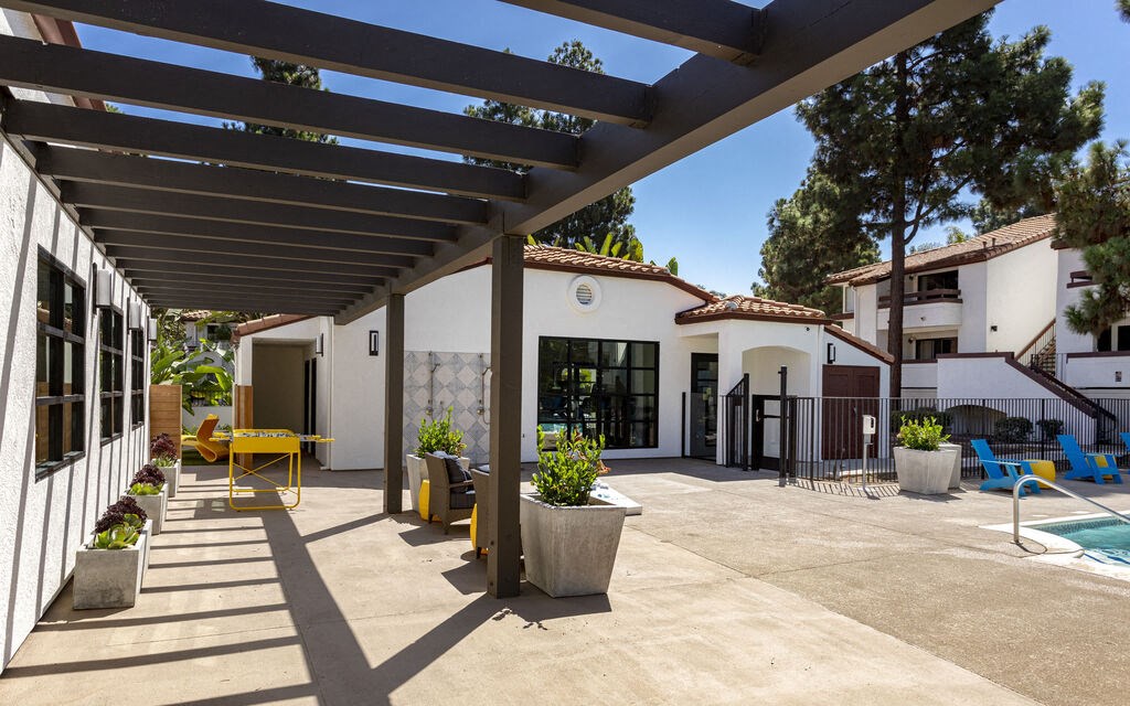 a patio with a white building and a swimming pool at La Jolla Blue, California