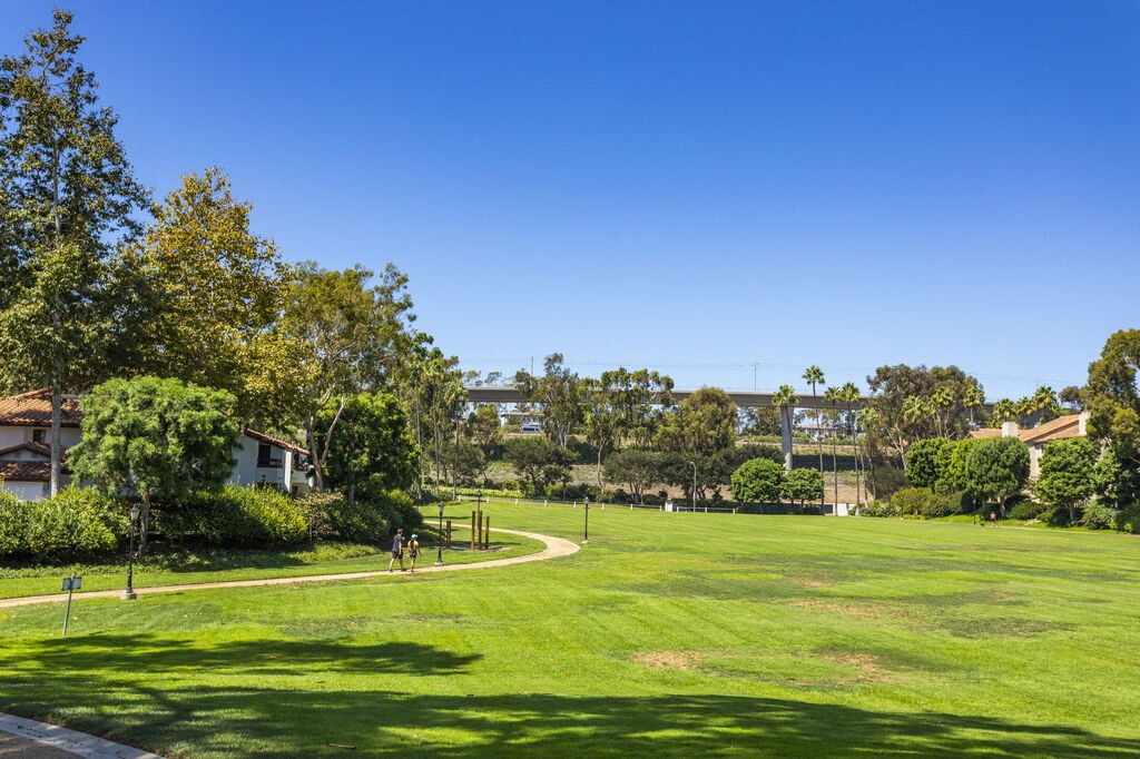 a large grassy field with trees and a blue sky at La Jolla Blue, California, 92122