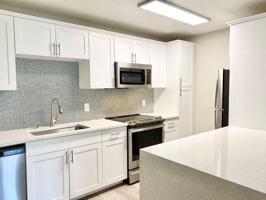 a kitchen with white cabinets and a counter top at La Jolla Blue, California
